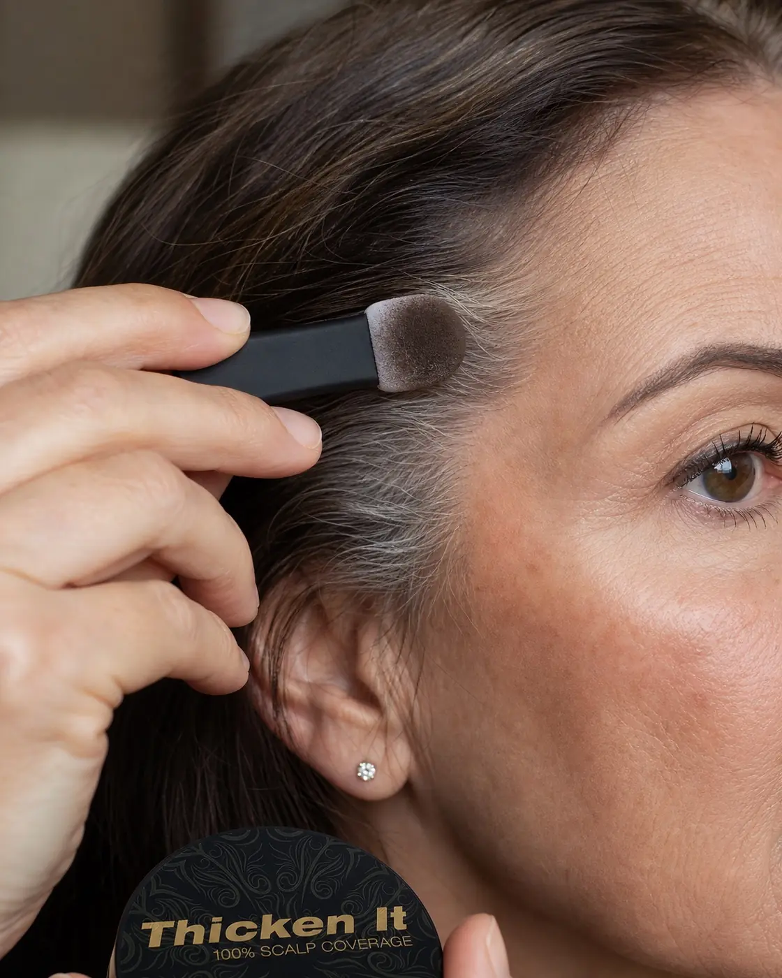 Close-up of gray hair coverage blended along the temple for a soft, natural finish