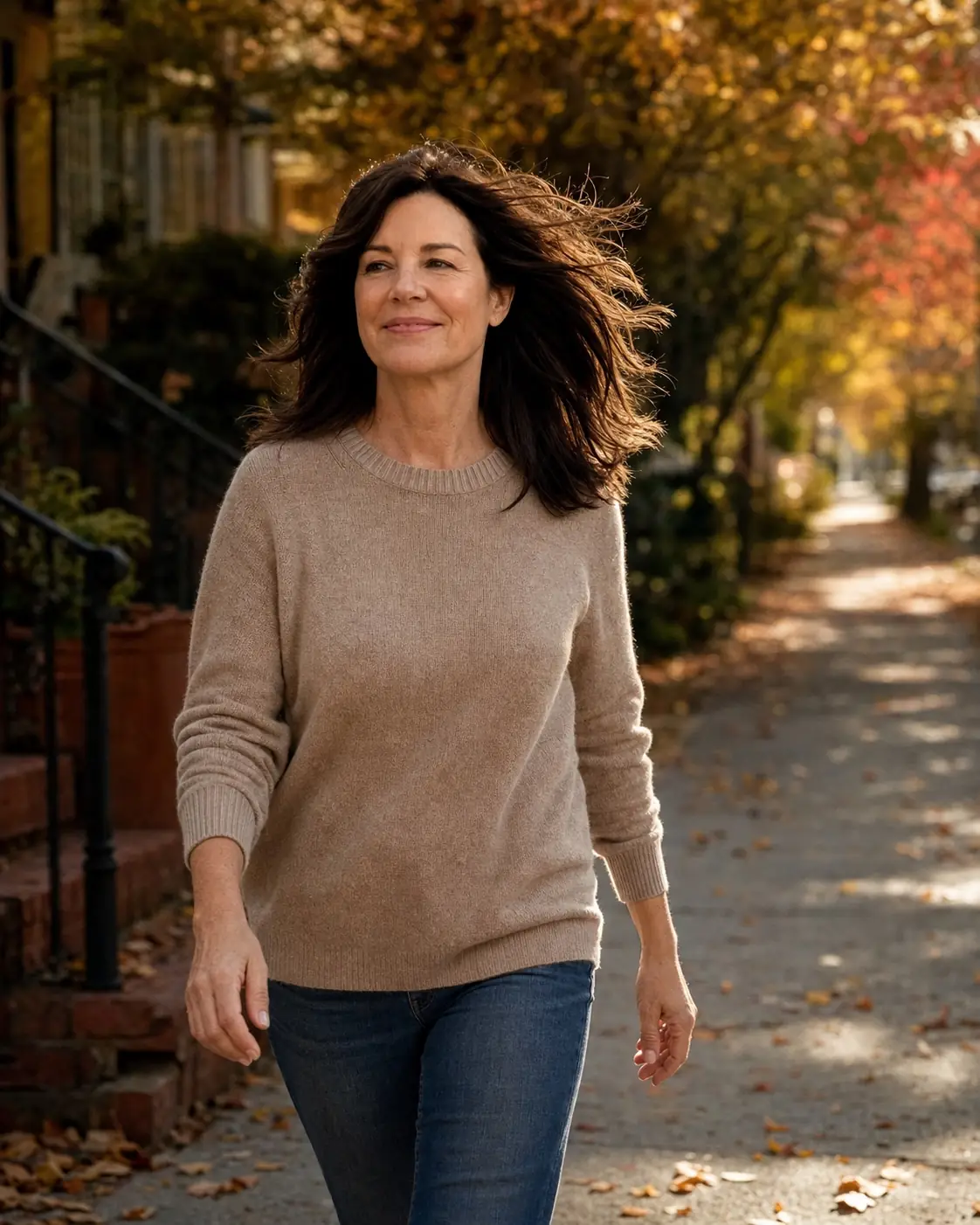 Woman walking outdoors on a breezy autumn day with her hair lifting, scalp coverage still holding at the part